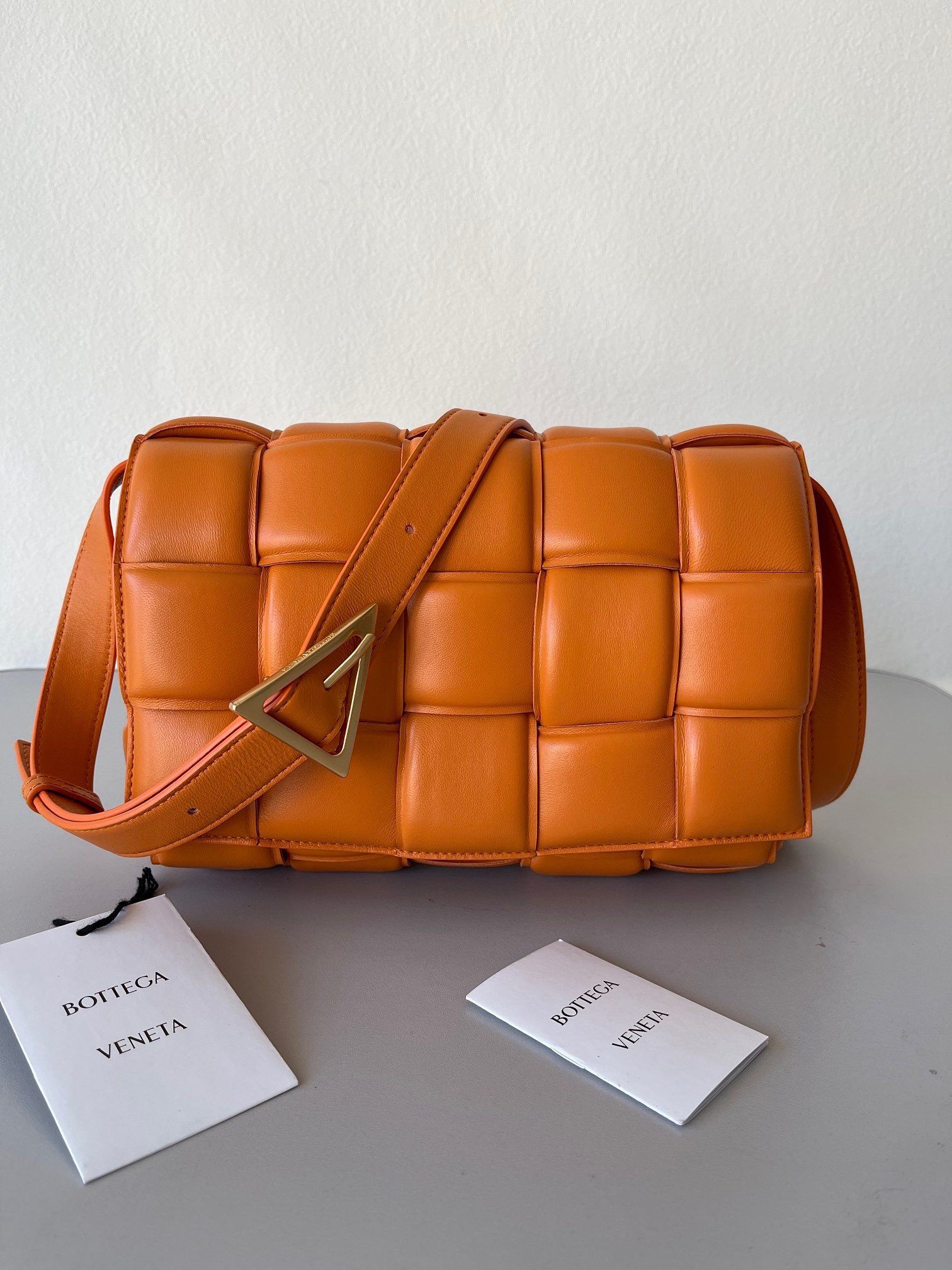 Bottega Veneta Padded Cassette Bag In Orange Intrecciato Lambskin