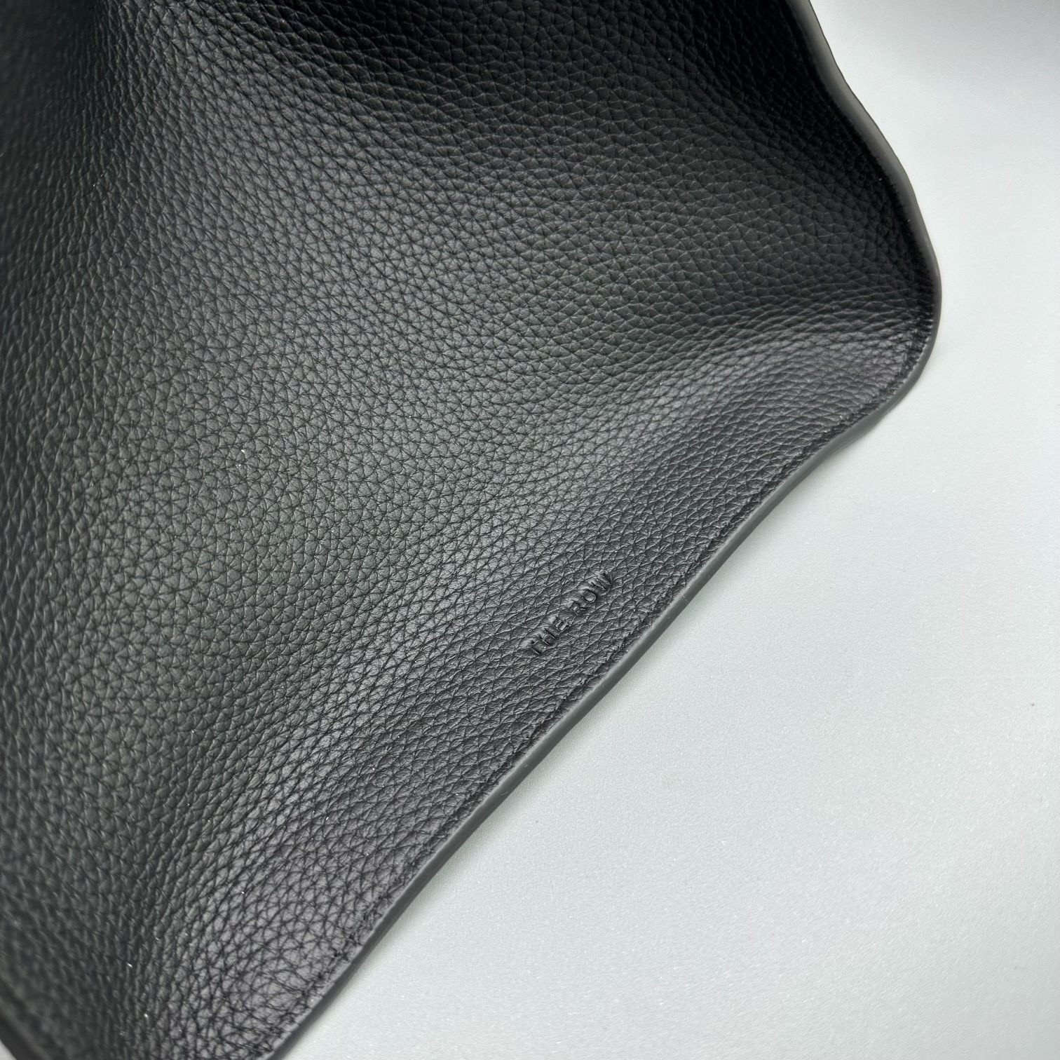 The Row Margaux 17 Top Handle Bag in Black Grained Leather